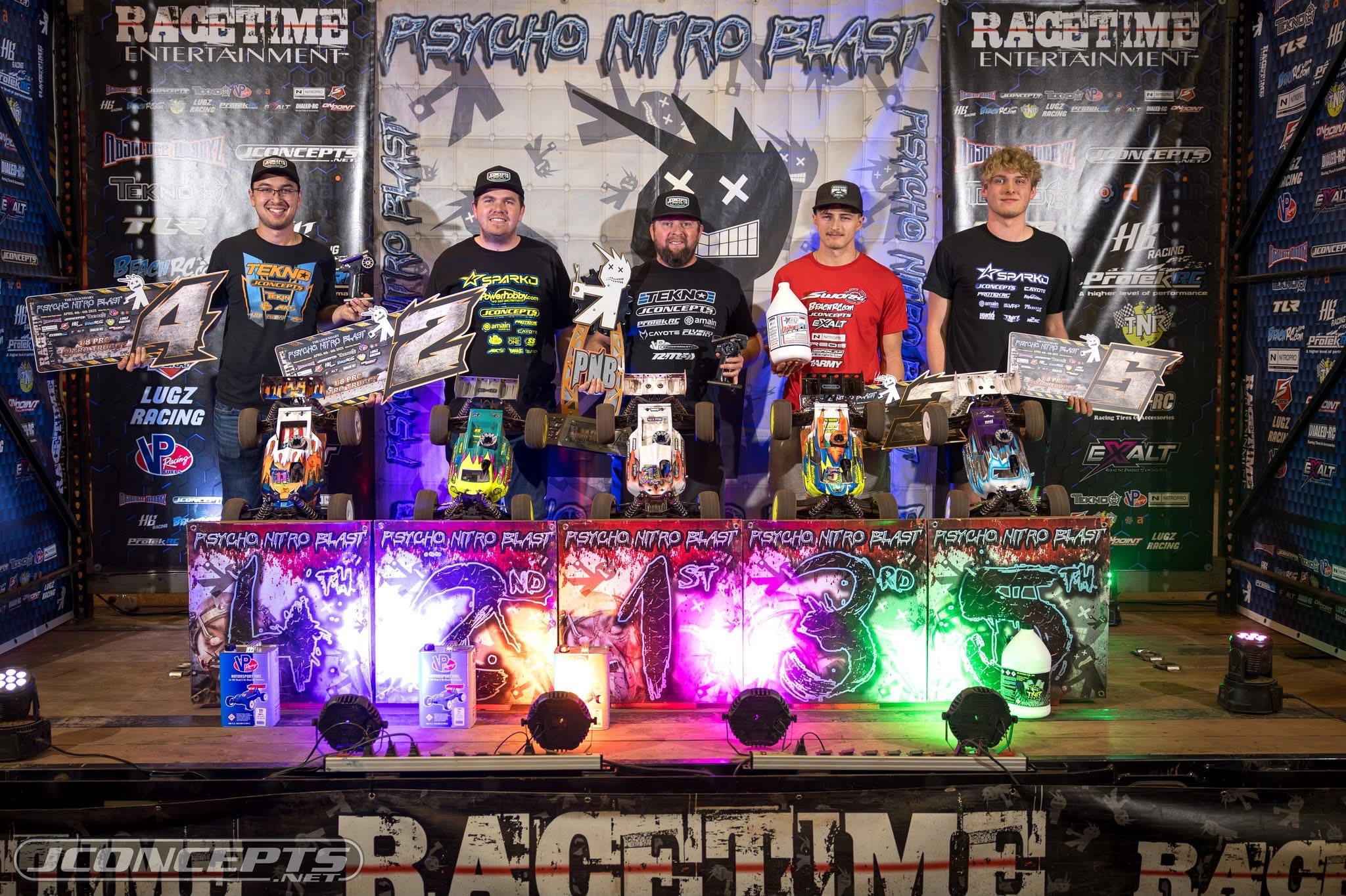 Lee Setser posing with Sparko RC cars and branded trophies at a Psycho Nitro Blast podium