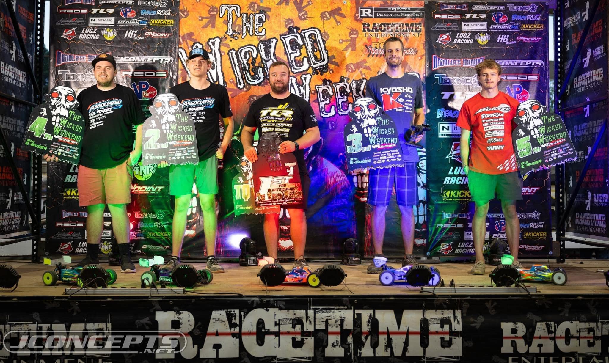 Lee Setser posing with Sparko RC cars and branded trophies at Racetime Entertainment event Wicked Weekend